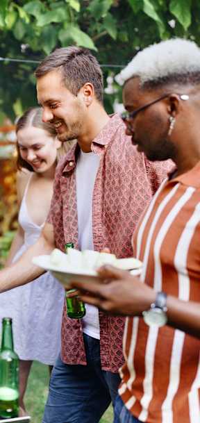 A group of people are gathered around a barbecue grill.