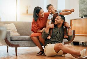 a family sitting on the floor in their living room