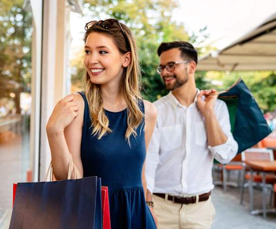 portrait of a young couple with shopping bags at The Rialto, Orlando