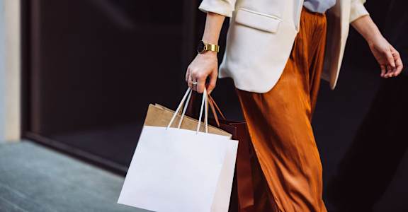 a woman holding shopping bags in her hand at Hamilton Manor Apartments, Hyattsville, 20782