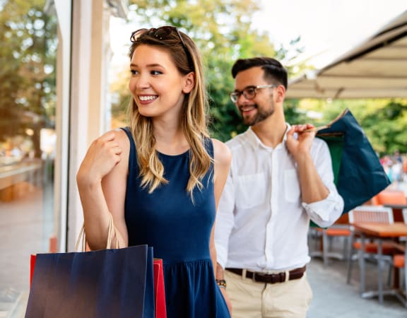 portrait of a young couple with shopping bags