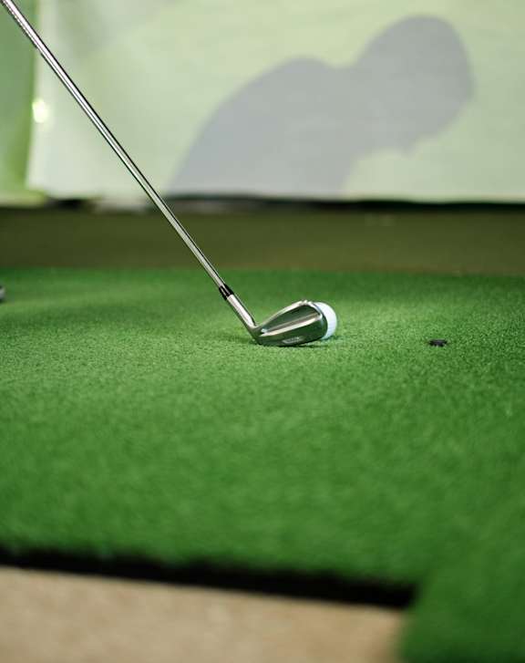 A golf club is stuck in the ground.