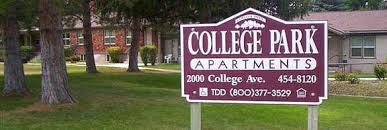 A sign for College Park Apartments is displayed in front of a building.