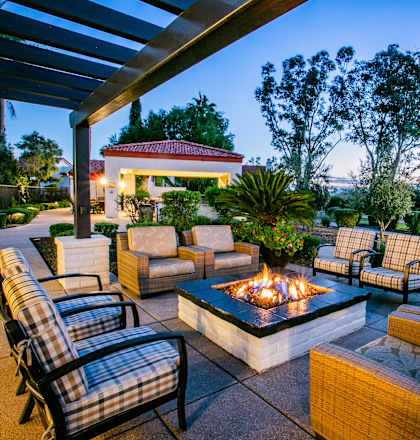 a patio with furniture and a fire pit