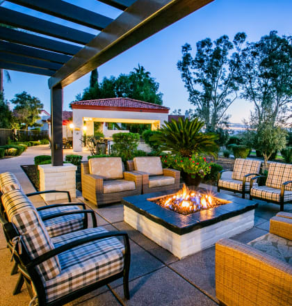 a patio with furniture and a fire pit