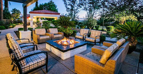 a patio with furniture and a fire pit