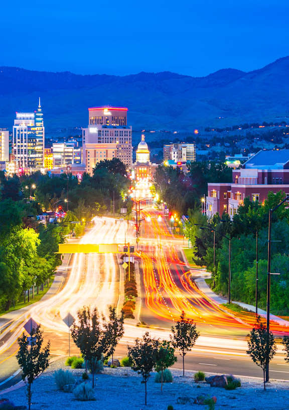 A cityscape at night with a long exposure of the street lights.