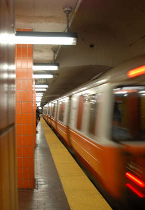 a subway train speeding through a subway station