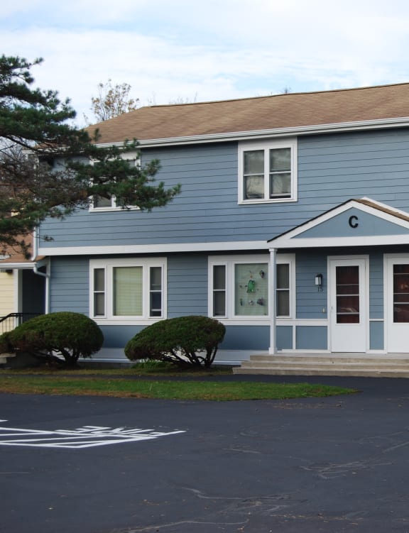 a row of houses with a sidewalk and grass
