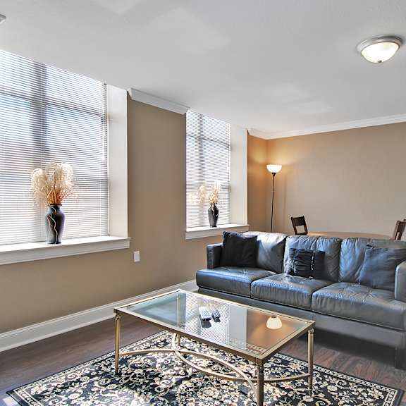 Living room with hardwood floors and natural light at Bancroft Luxury Apartments in Saginaw, MI