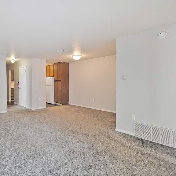 Living room with carpet and large windows at Hunters Ridge in Kalamazoo, MI