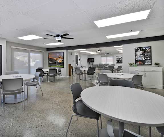 A conference room with a white table and chairs.
