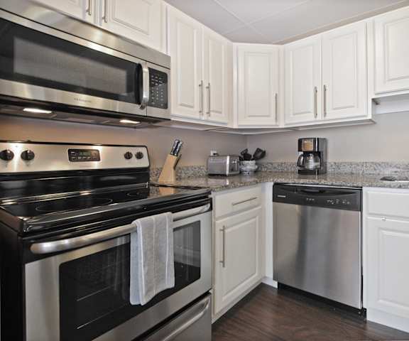 a kitchen with stainless steel appliances and white cabinets