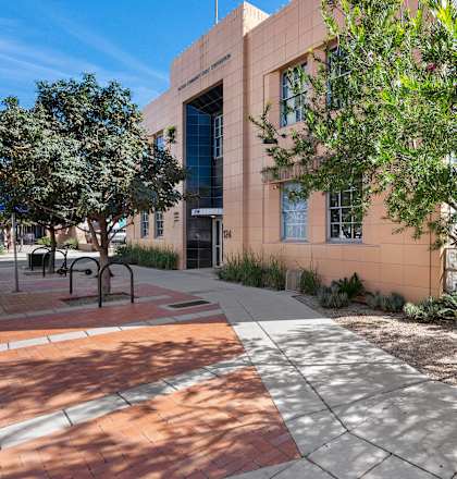 A building with a tree in front of it.
