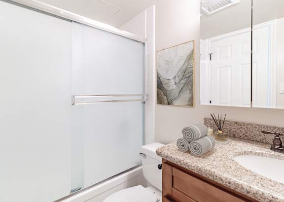 a bathroom with a toilet sink and shower