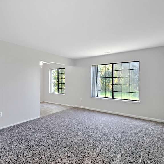 Open carpeted living room at Garfield Commons in Clinton Township, MI