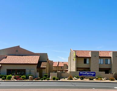 A building with a sign that says Wind Springs in front of it.