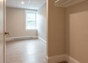 Thumbnail 5 of 7 - A room with a window and a door.