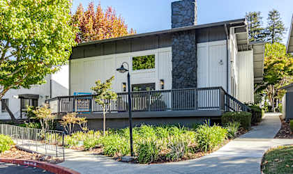 an exterior view of a building with a porch and a sidewalk