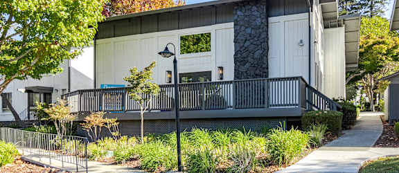 an exterior view of a building with a porch and a sidewalk