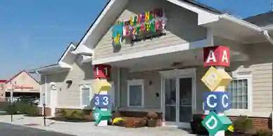 a house with alphabet signs in front of it