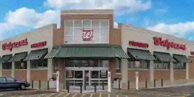 a shopping center with a store and a car parked in front of it