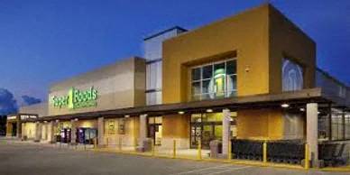 a large building with a grocery store at night
