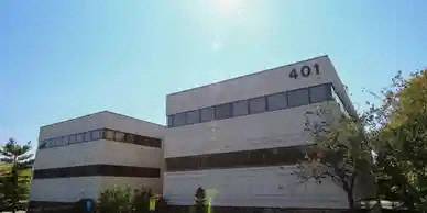 a large white building with a blue sky in the background