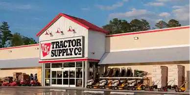 a tractor supply co store with a train in front of it