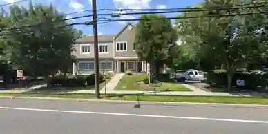 a house on the side of a street with a street light