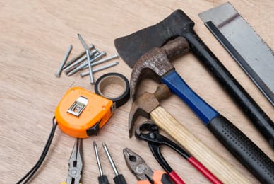 a selection of tools on a wooden surface