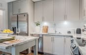 Thumbnail 2 of 35 - a kitchen with white cabinets and marble countertops