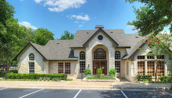 A large house with a stone facade and a large front door.