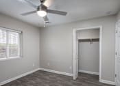 Thumbnail 6 of 34 - A room with a ceiling fan and a doorway leading to another room.