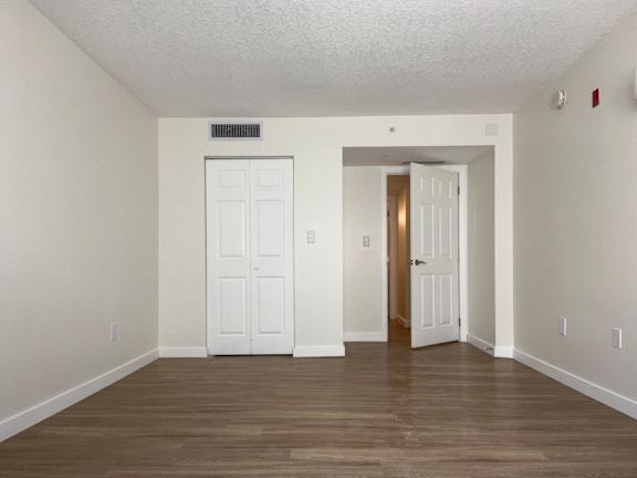 an empty living room with white walls and white doors  at Palm Gardens @ Biscayne Gardens, North Miami, Florida