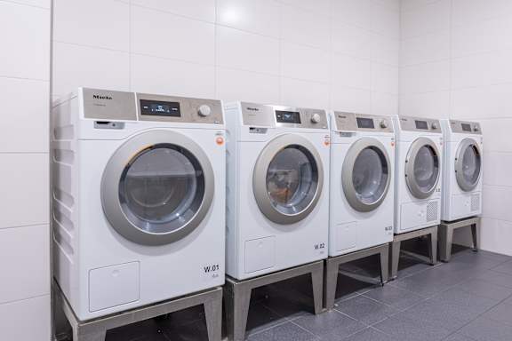 A row of washing machines in a laundromat.