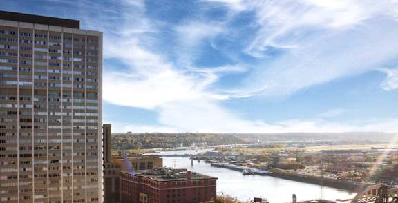 A view of a cityscape with a river and buildings.