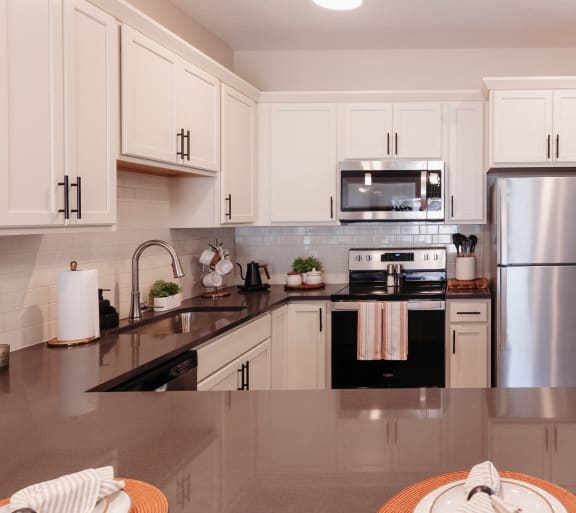 a kitchen with stainless steel appliances and a island with bar stools