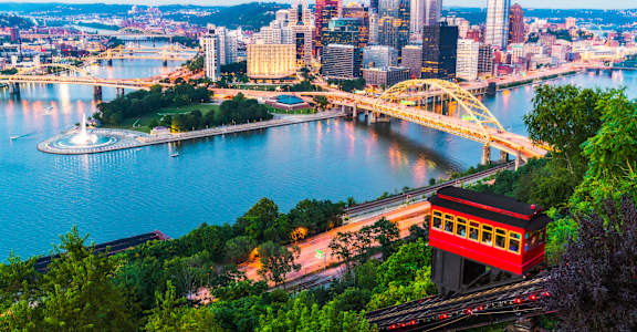 A cityscape with a river and a bridge.