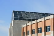 Thumbnail 3 of 3 - the top of a brick building with solar panels on top