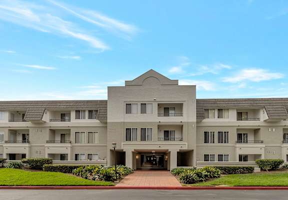a large apartment building with a blue sky in the background at Nobel Court, California
