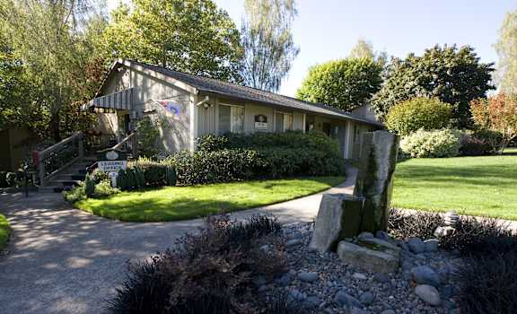 the front of a house with a driveway and a porch