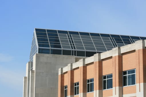 the top of a brick building with solar panels on top