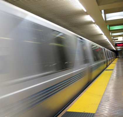 a subway train speeding through a subway station
