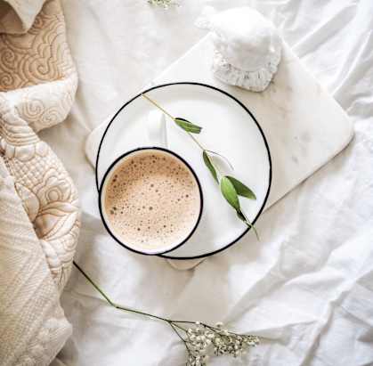 a cup of coffee with a flower on a plate