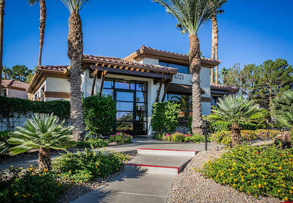 a building with palm trees in front of it
