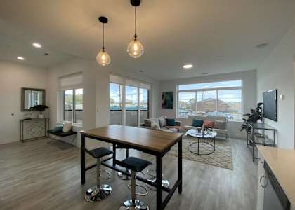 a large living room with a large wooden table and chairs