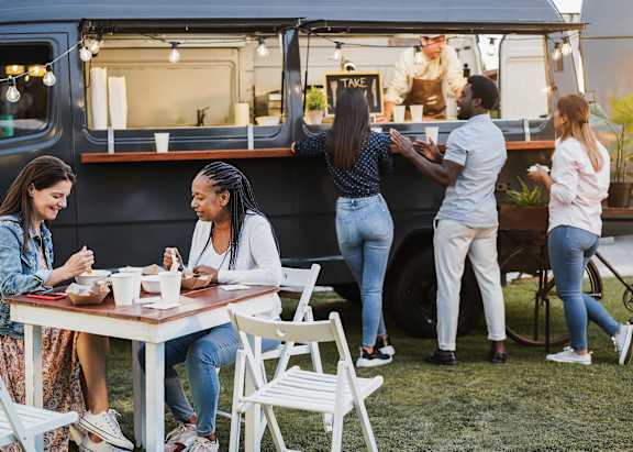 A group of people are gathered around a food truck.