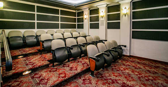 a conference room with a red carpet and chairs