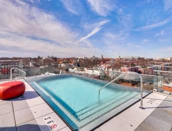 A small rectangular pool with a glass cover and a red float in the middle.